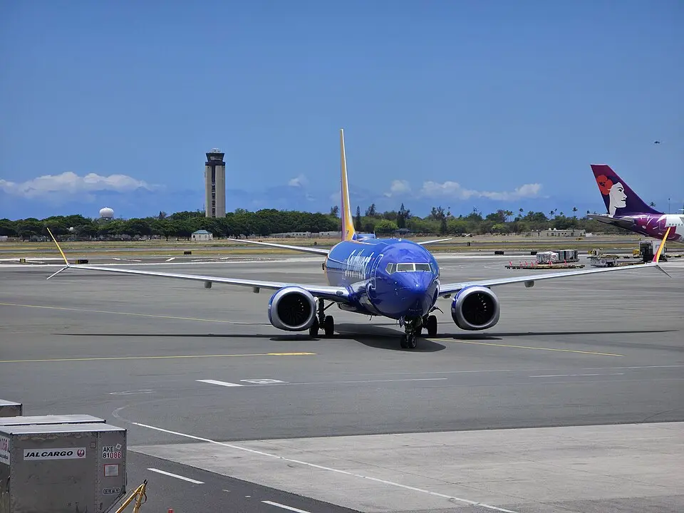 Southwest Airlines Boeing 737 MAX 8 taxiing on the ramp near a control tower