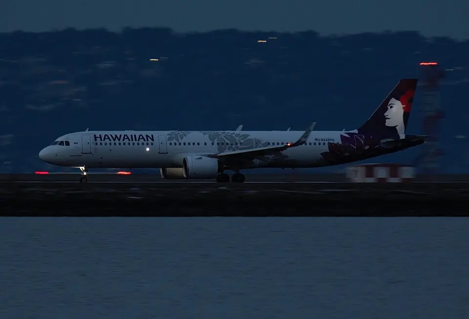 Hawaiian Airlines Airbus A321 taxiing on the runway at dusk