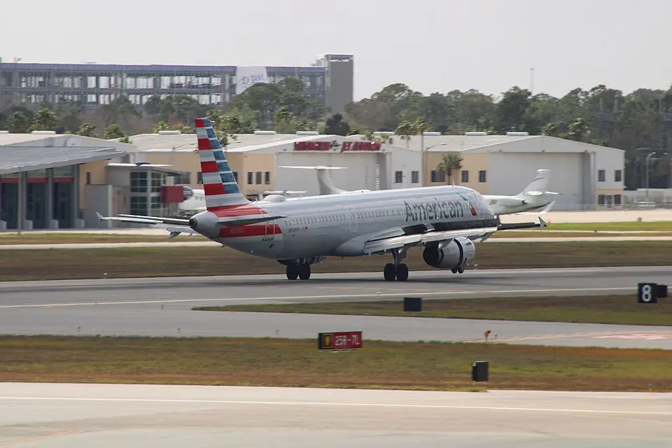Delta Air Lines Airbus A321 taxiing on the runway near airport buildings
